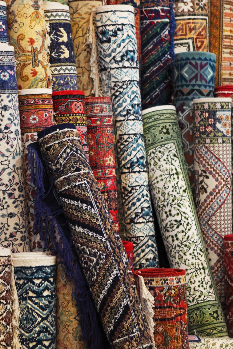 Rugs of different colors and sizes and designs rolled up for storage - Jacksonville, IL