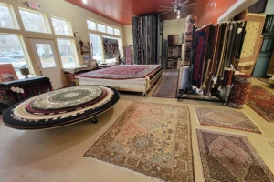 Multiple styles and designs of rugs on display in Springfield, IL, showcasing various rug sizes.