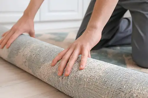 The Rug Rack & Murphy Rug Cleaners—A man rolls up a rug to prepare to move to a new house in Springfield, IL.